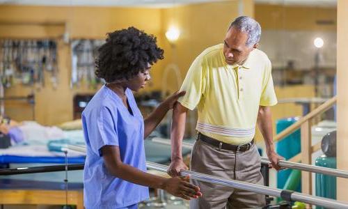 Orlando physical therapist assistant helping elderly patient regain balance